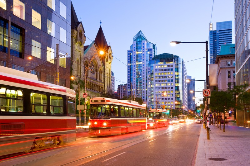 A streetcar on a Toronto avenue at dusk